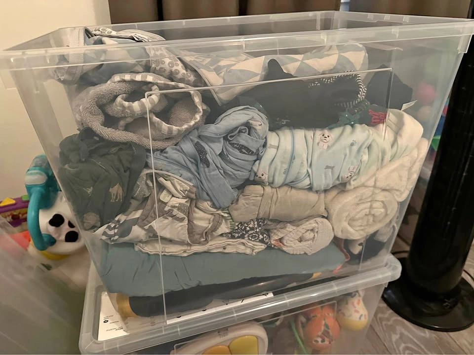 Misc bin of baby clothes