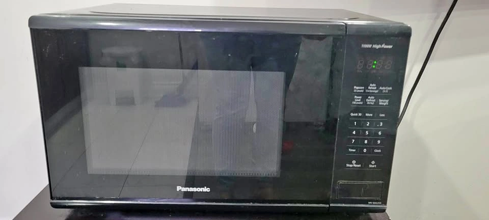 Panasonic 1100W high-power microwave in black.