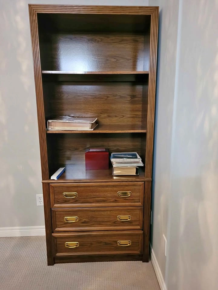 Dark wood bookcase with 3 shelves and 3 drawers