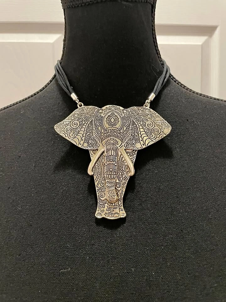 Silver elephant necklace on a black cord