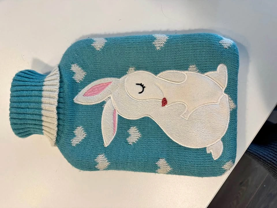 Hot water bottle with soft cover