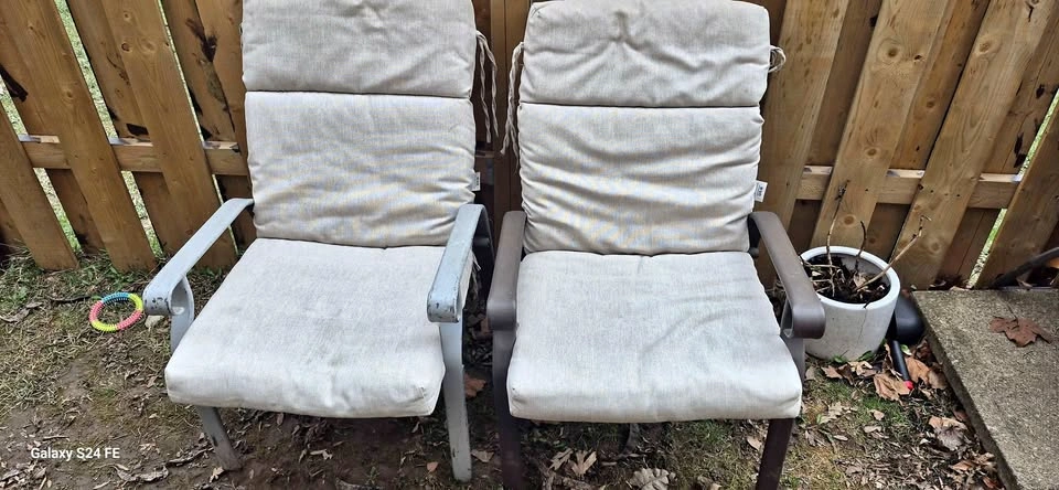 Two patio chairs with an extra cushion