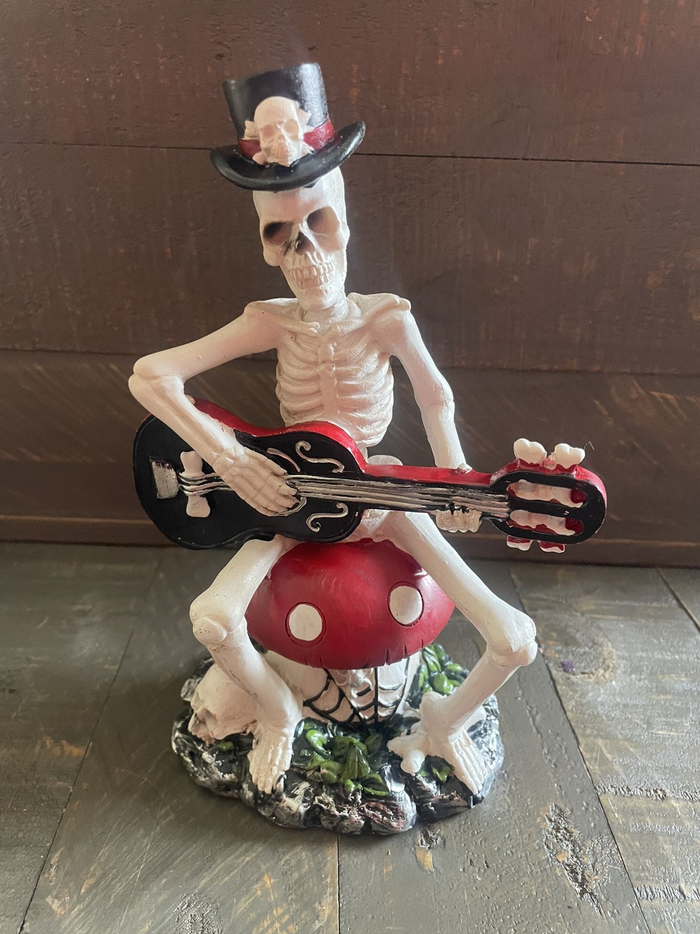 Resin Skeleton Playing Guitar On A Mushroom