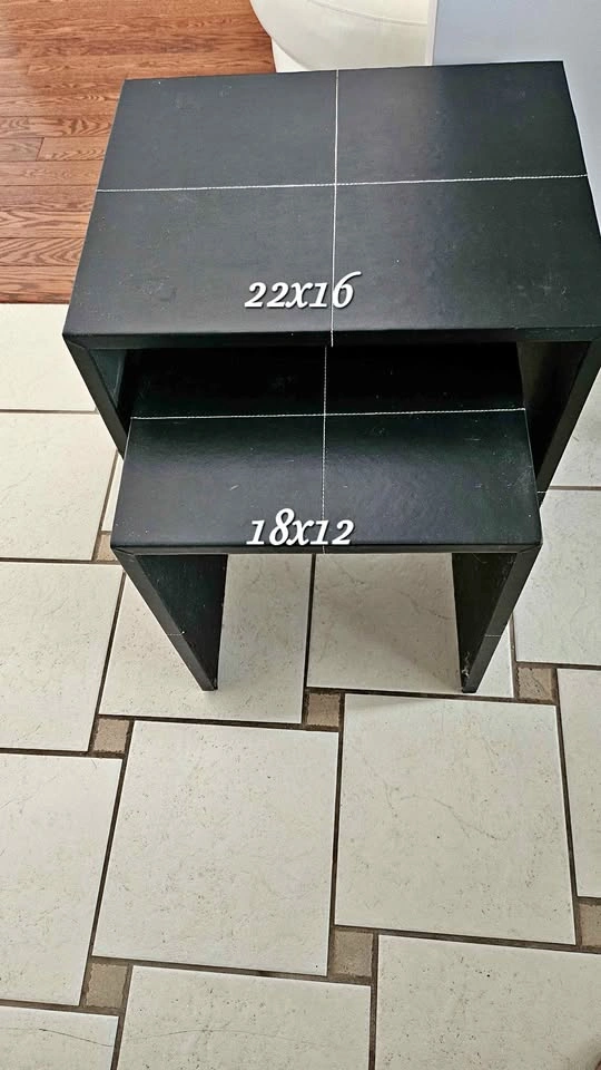 Nesting end tables, crafted from leather with white stitching.