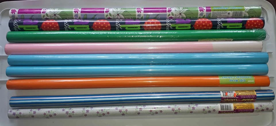20 rolls assorted wrapping paper & cello w/ bin