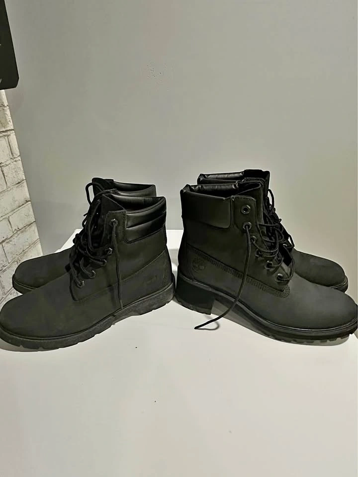 Two pairs of black Timberland boots
