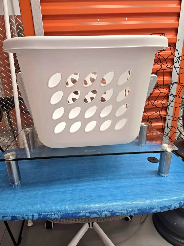 White plastic laundry basket with handles
