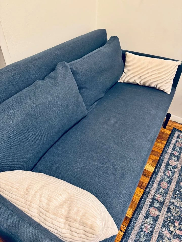 Blue couch with fold-out bed, compact for small spaces!