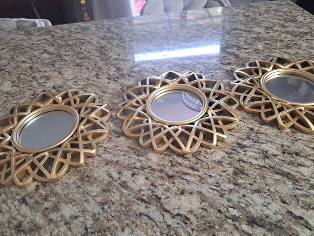 3 small gold mirrors