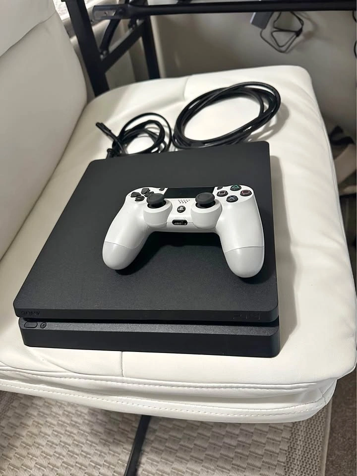PlayStation 4 slim in like-new, mint condition - barely used.