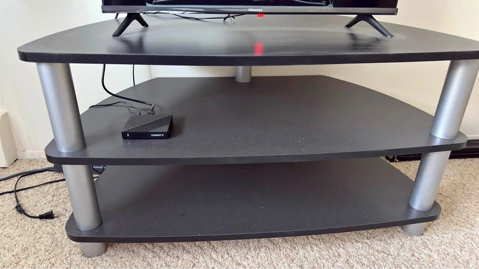Black 3-tier TV stand with silver legs