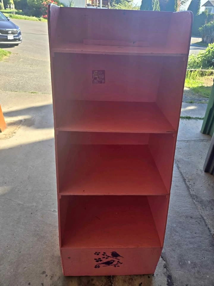 Cute pink wooden shelf with stenciled designs