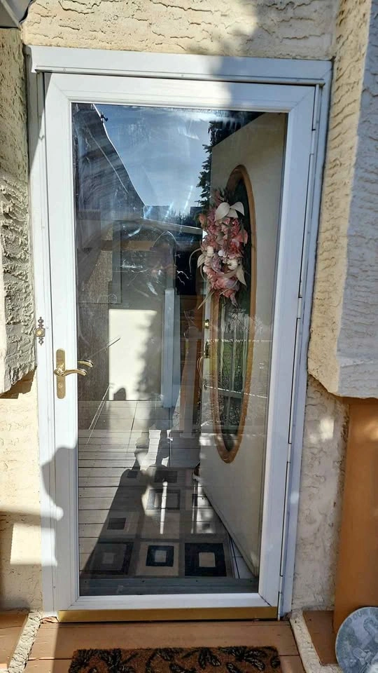 White and glass storm door
