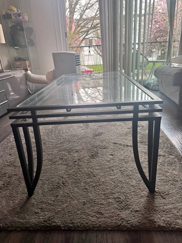 Glass top coffee table with black metal base