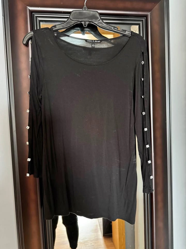 Black blouse with arm openings and decorative buttons