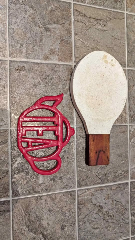 Red Cast Iron Trivet and White Ceramic Spoon Rest