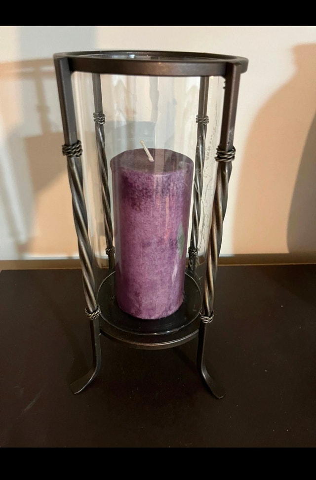 Two glass candle holders with purple candles