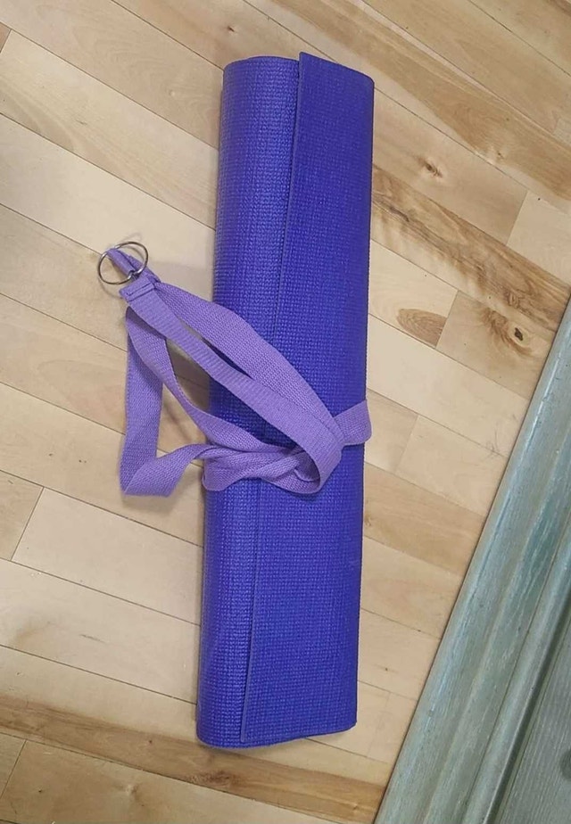 Purple yoga mat and matching strap.