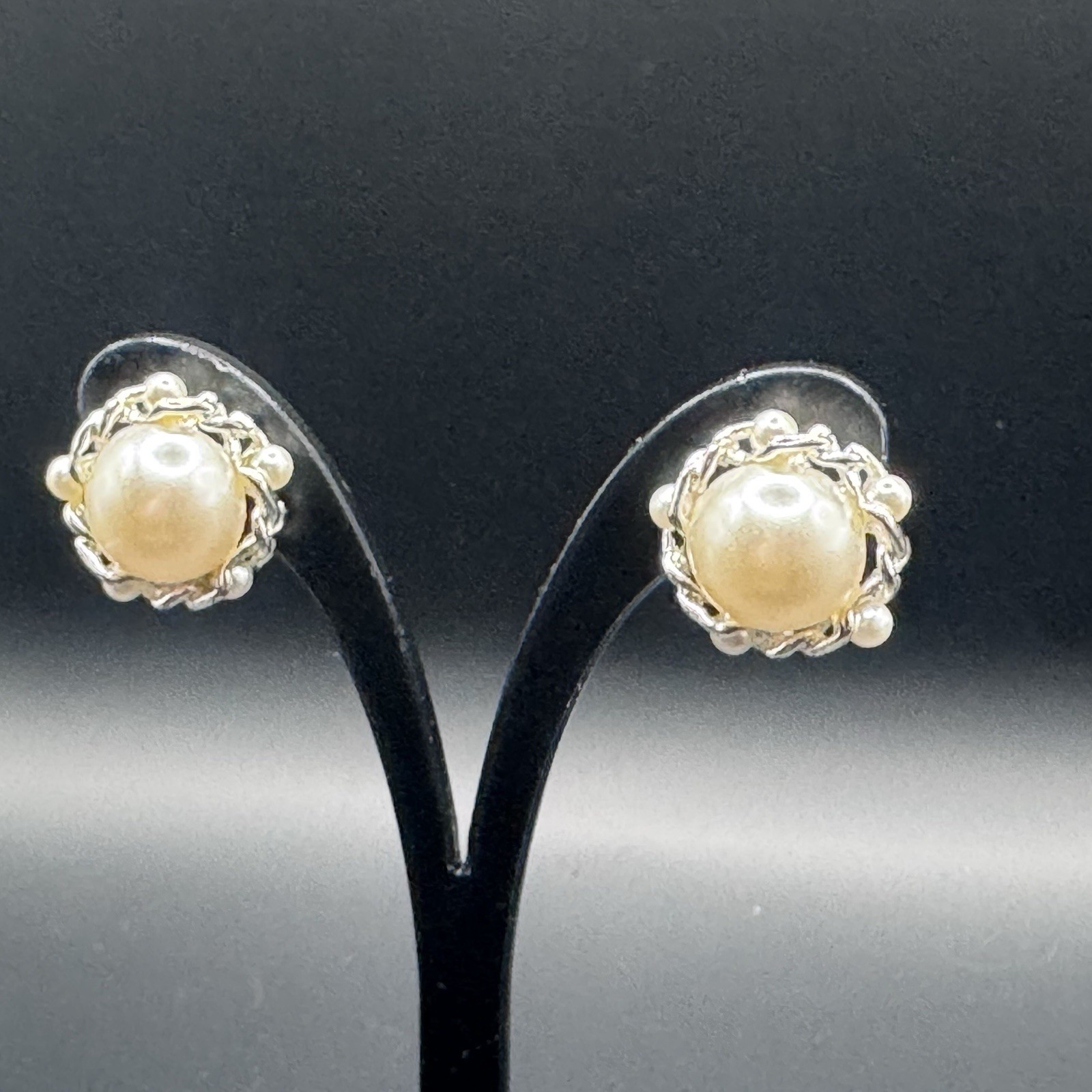 Small, round, faux pearl and silver toned clip on earrings