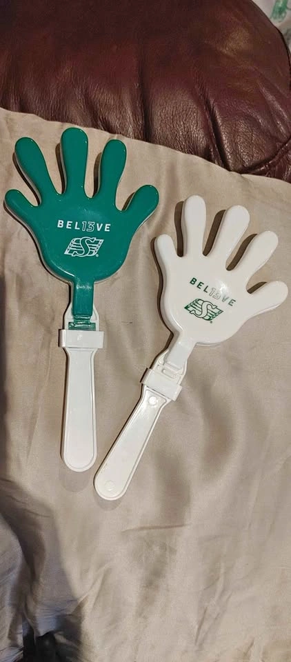 Saskatchewan Roughriders Fans. 2 green and white hand clappers.