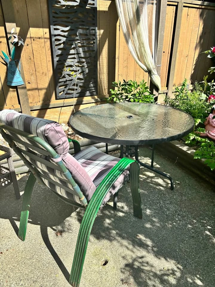 Green glass patio table with chairs