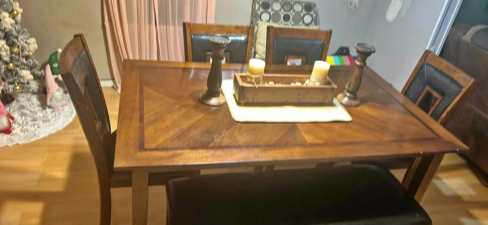 Dining table with four chairs and a bench.