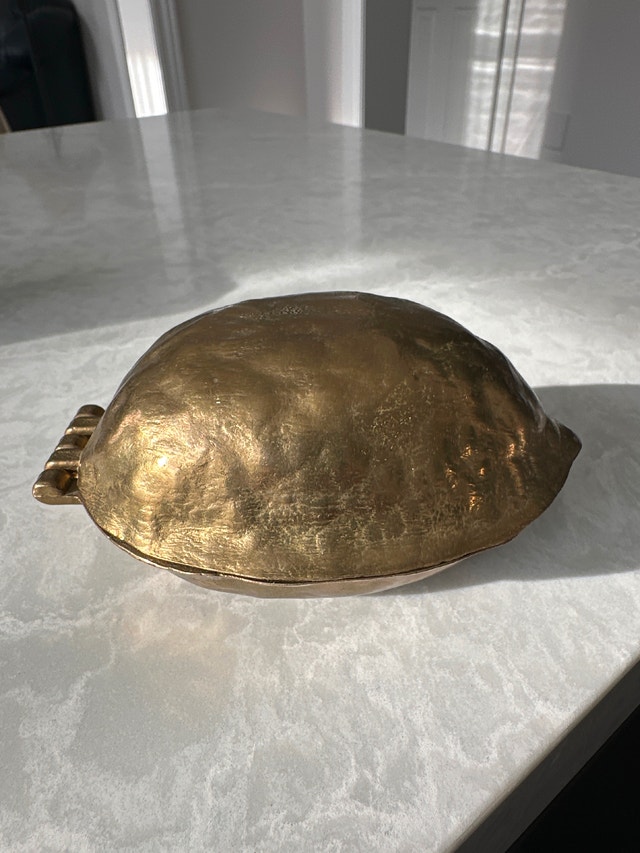 Solid brass vintage nutcracker shaped like a walnut