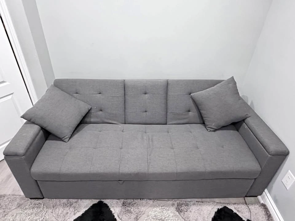 Grey pull out sofa bed with storage