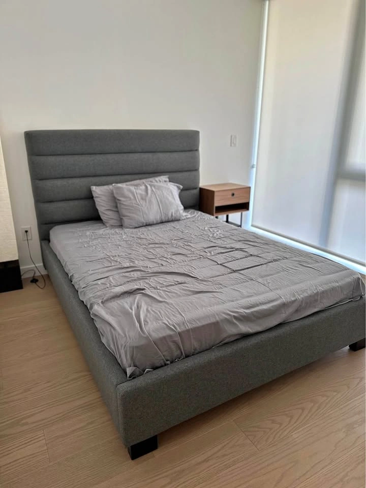 Grey upholstered queen bed frame and mattress