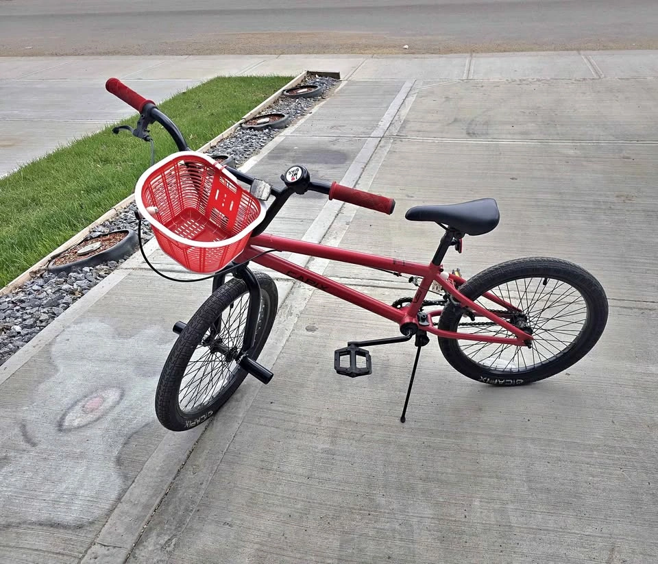 Red CAPIX BMX bike with basket and pegs
