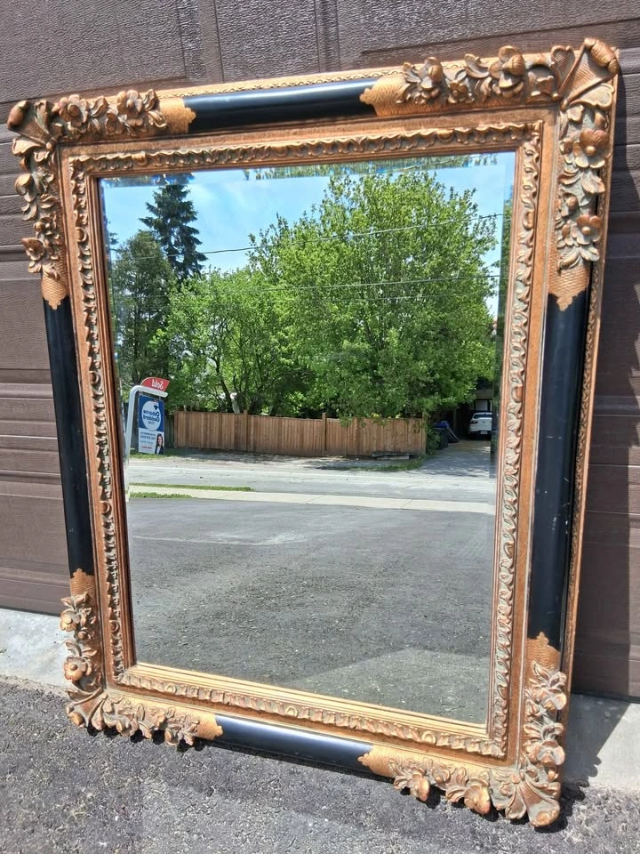 Antique ornate bronze and black mirror