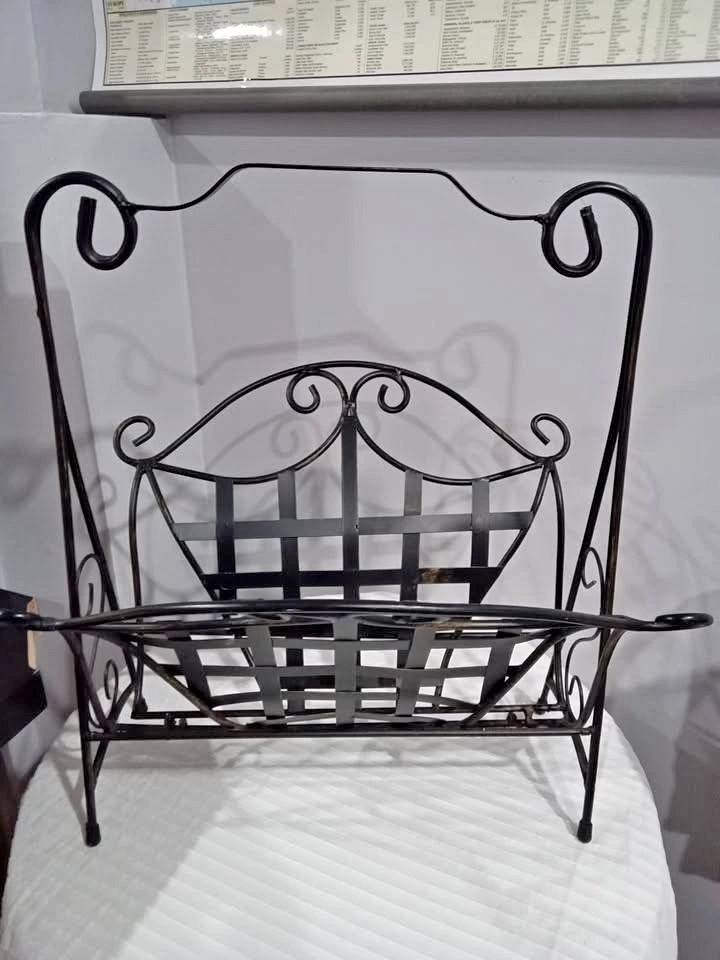 Vintage black wrought iron magazine rack. Foldable.