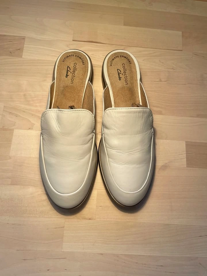 US 6.5, Clarks Trish Plant mules in ivory leather.