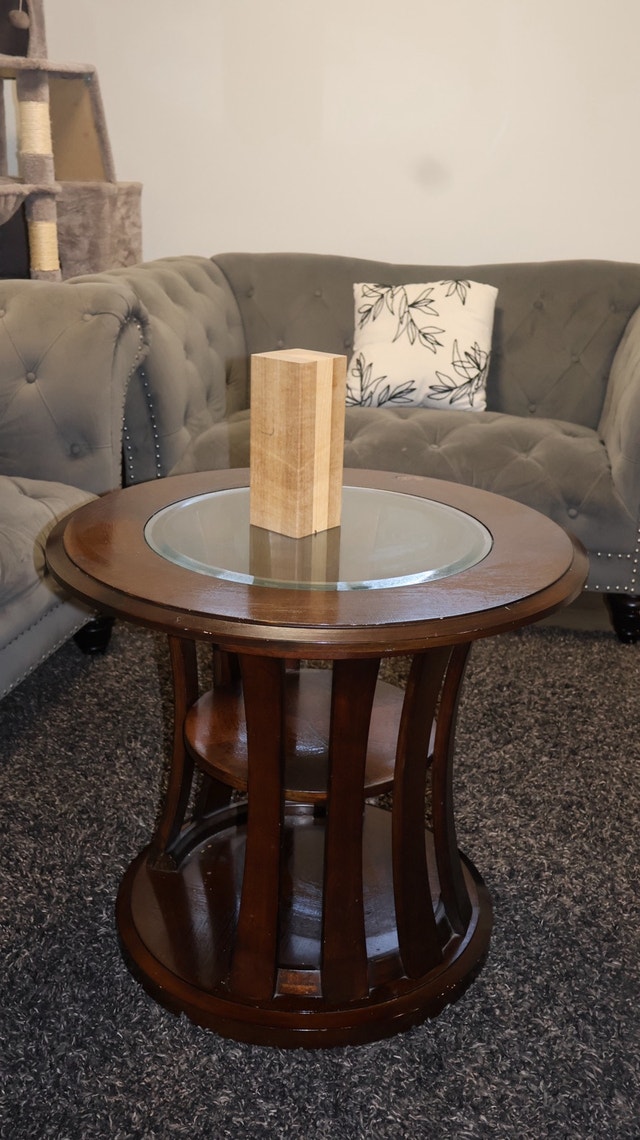 Round wooden end table with glass top