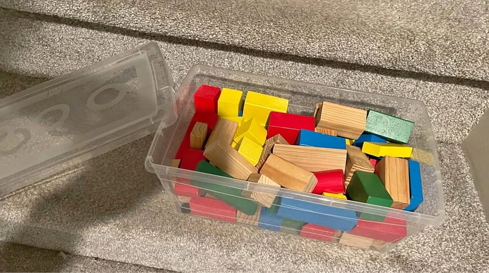 Shoe box size clear bin with wooden blocks
