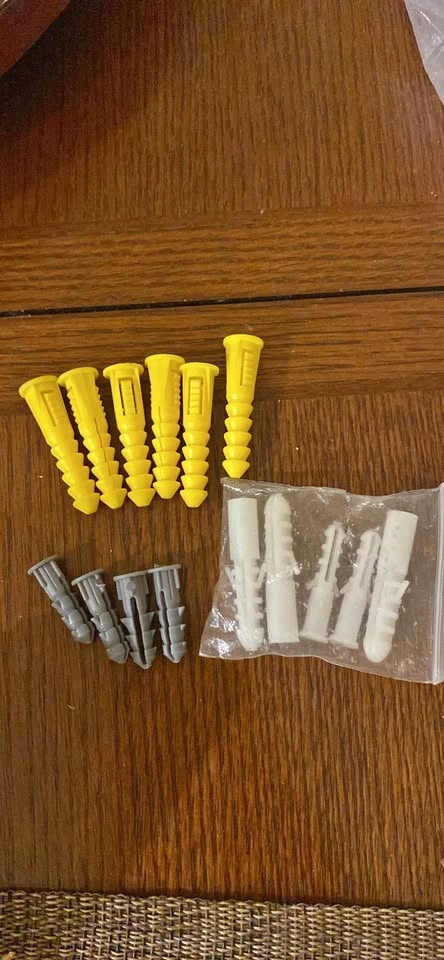 Assorted yellow, grey, white wall anchors