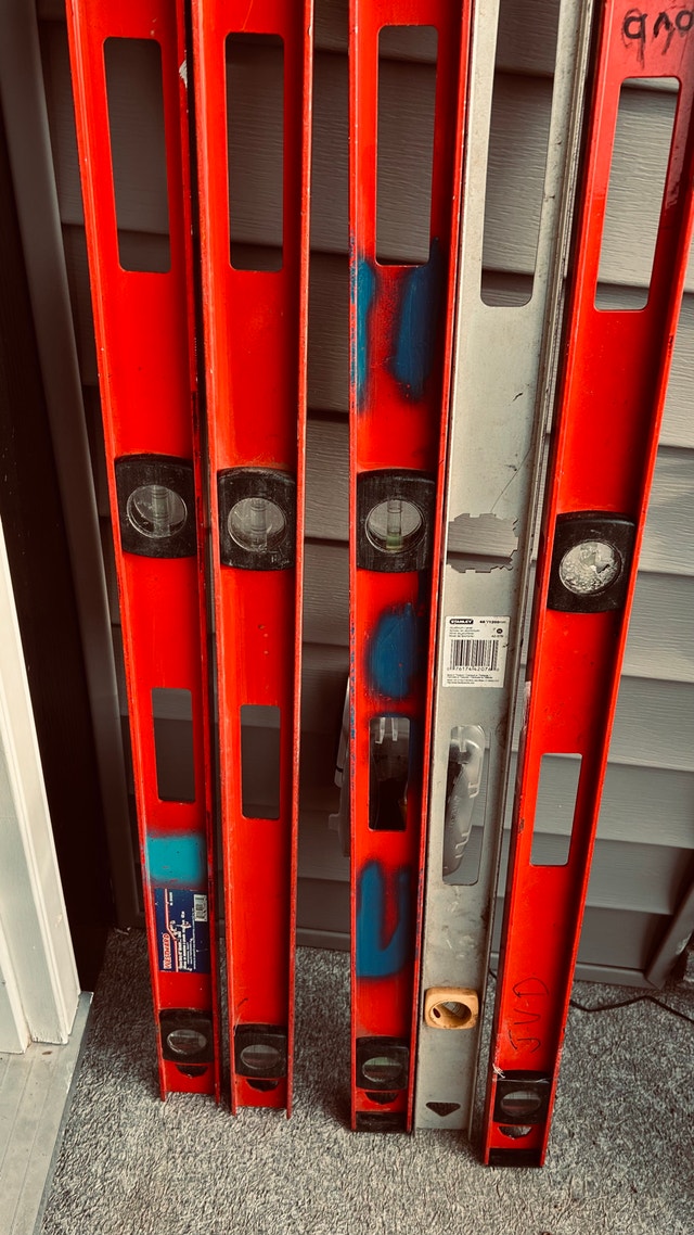 Lot of 5 four-foot levels for sale.