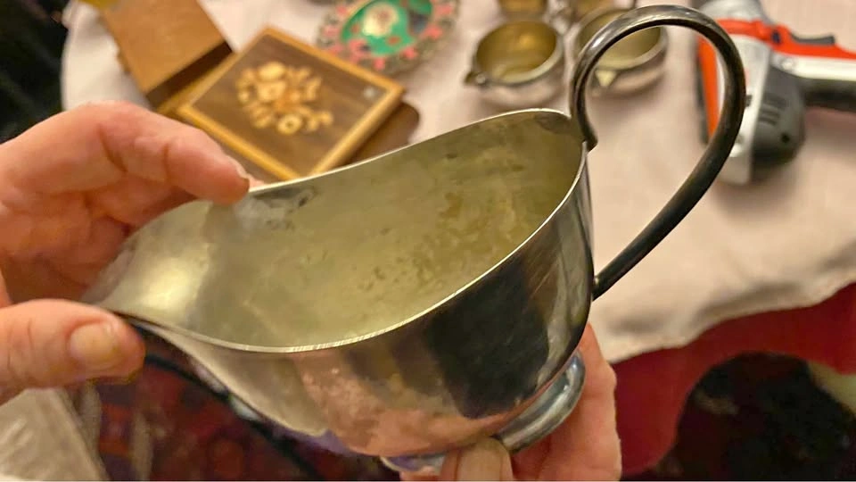 Silver colored gravy boat
