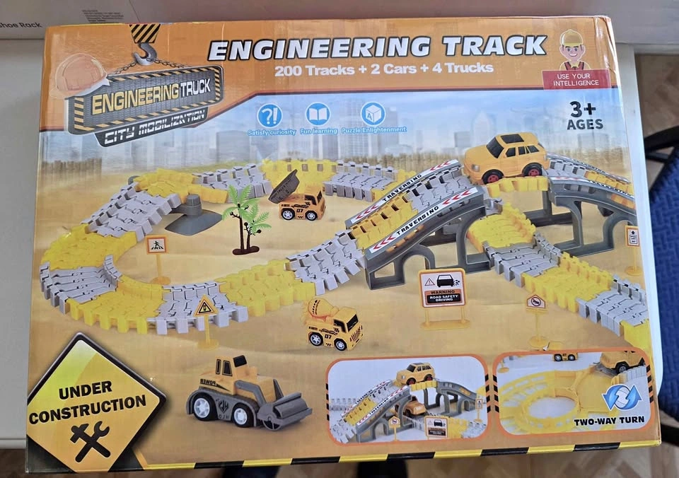 New, 200 tracks, 2 cars, 4 trucks included in box.