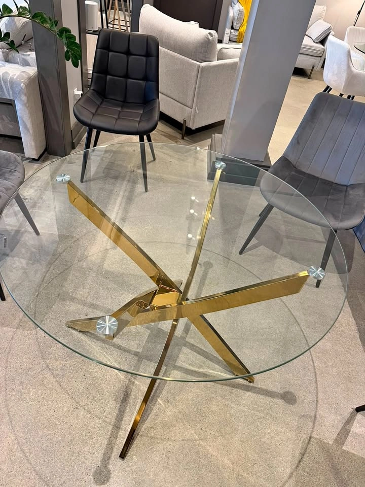 Elegant Sabine Gold dining table with a stylish round glass top