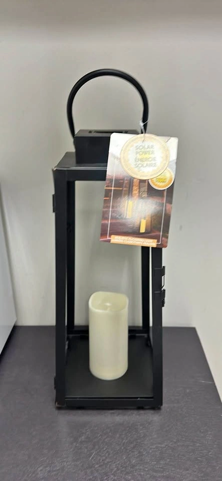 Black solar lantern with candle