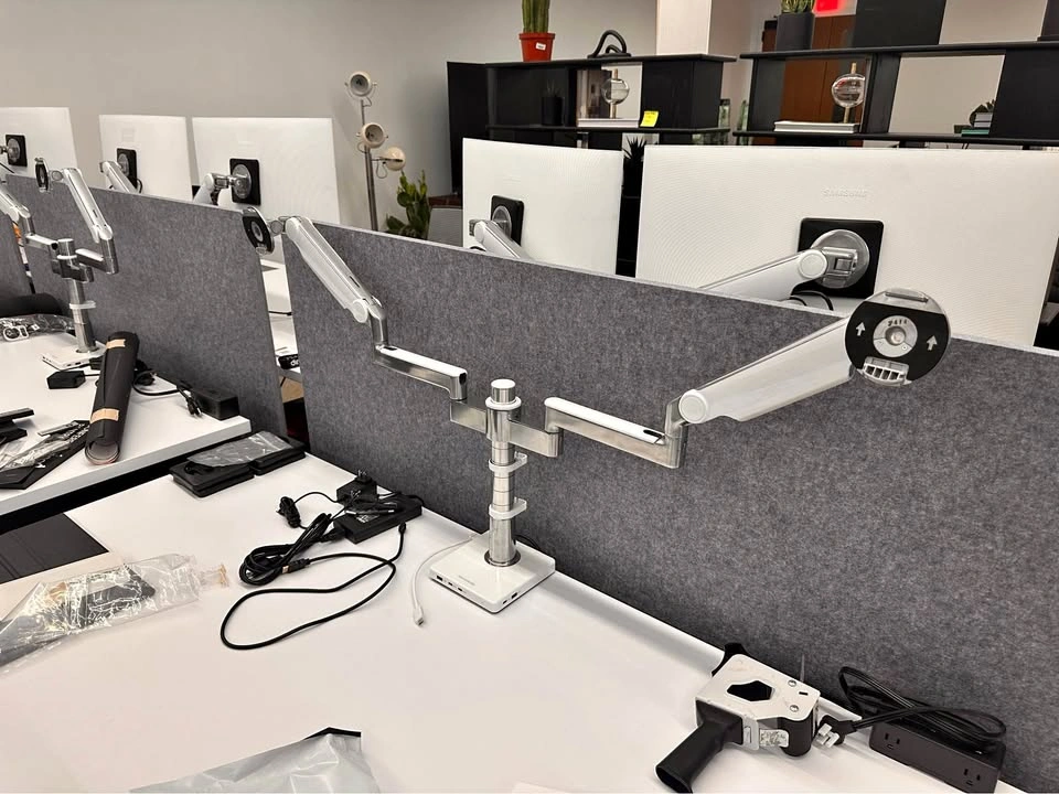 Human scale dual monitor arms with powered base