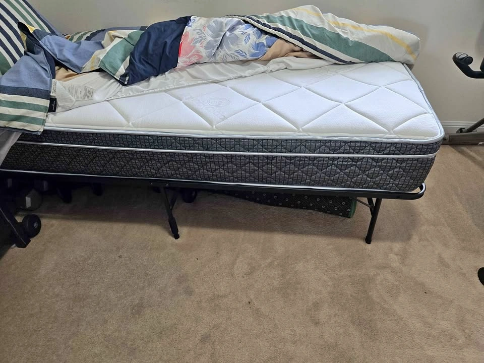Twin XL size mattress on metal frame