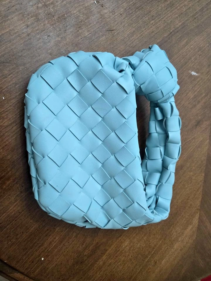 Brand new light blue woven handbag with knotted handle
