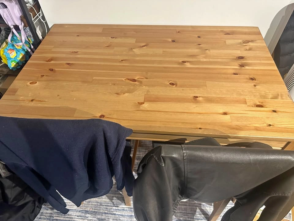 Wooden table with 4 matching chairs and 4 cushions