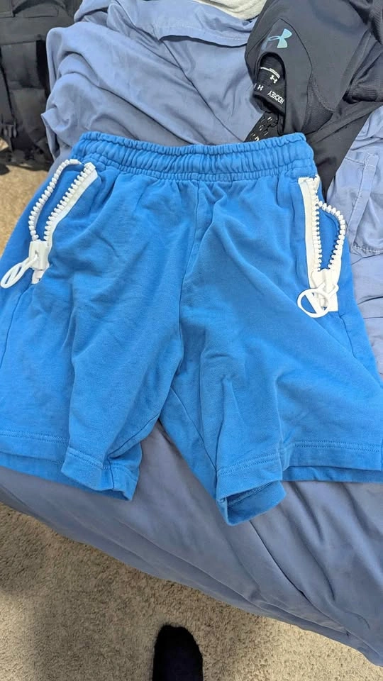 Bright blue shorts with white zippers