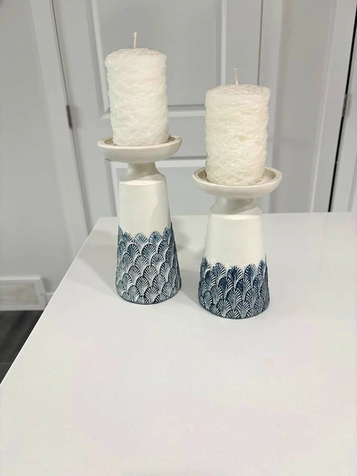 2 matching candle holders with candles