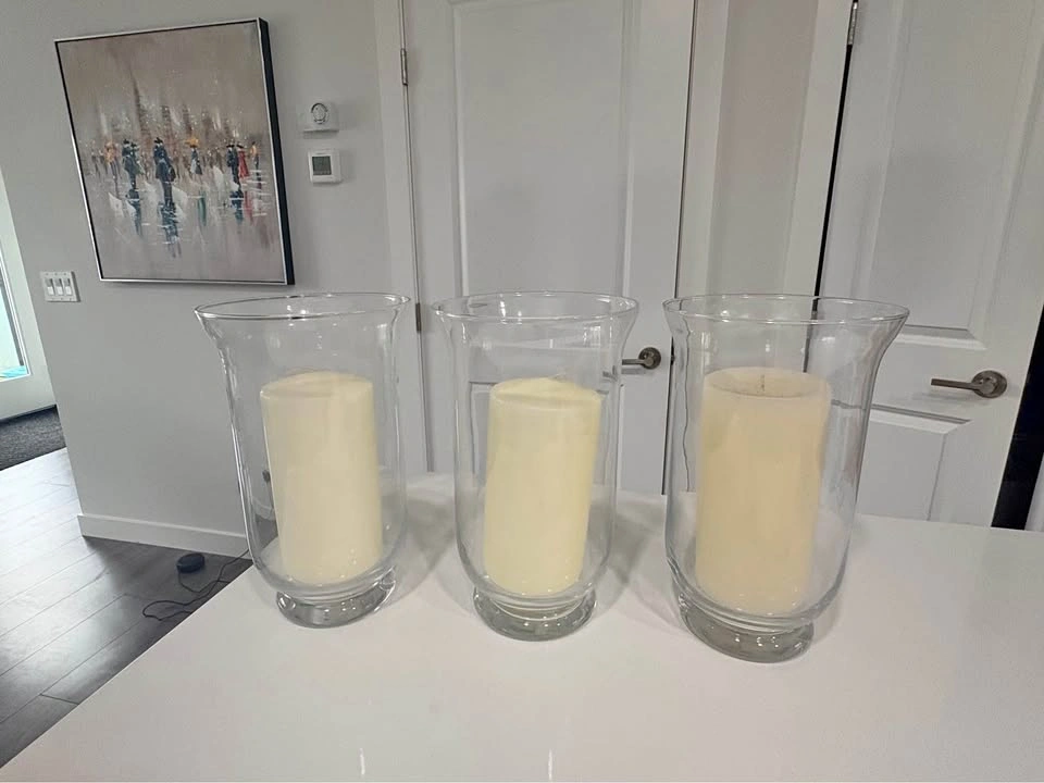 3 tall glass vases with pillar candles