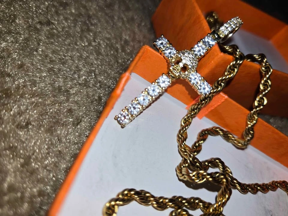 Gold chain with a cross-shaped pendant and a skull covered in zi - photo 2
