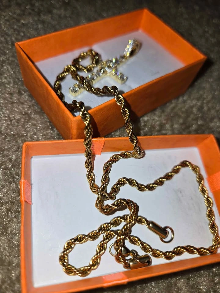 Gold chain with a cross-shaped pendant and a skull covered in zi - photo 3